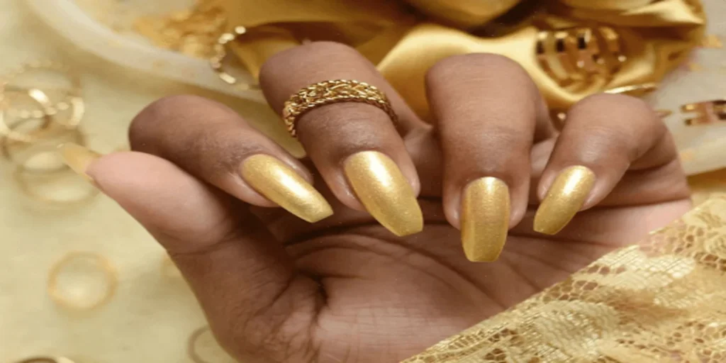 "A close-up image showcasing intricate Golden Nails Art, featuring elaborate designs and shimmering gold accents, adding a touch of glamour to manicured nails."